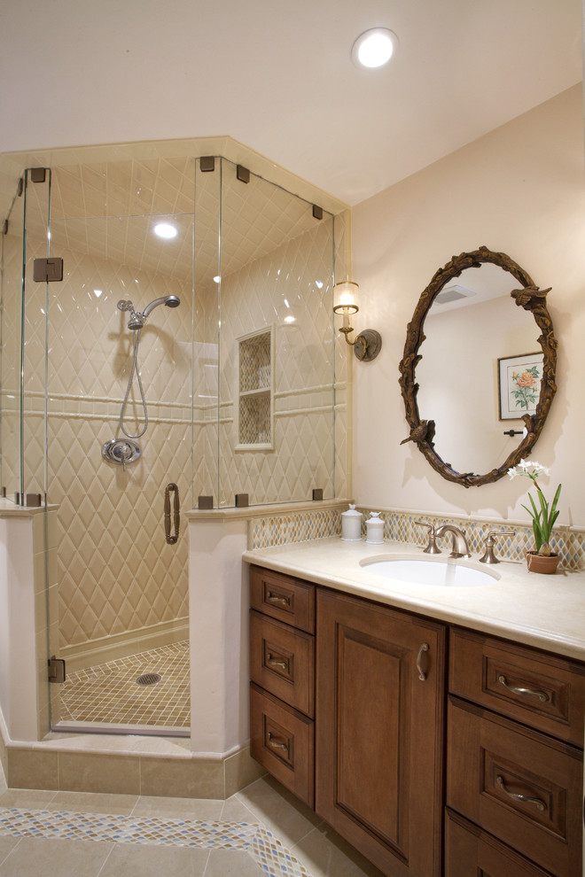 This is an example of a mid-sized traditional master bathroom in San Francisco with raised-panel cabinets, dark wood cabinets, a corner shower, beige tile, white tile, yellow tile, beige walls, porcelain floors, an undermount sink, porcelain tile, engineered quartz benchtops and beige floor.