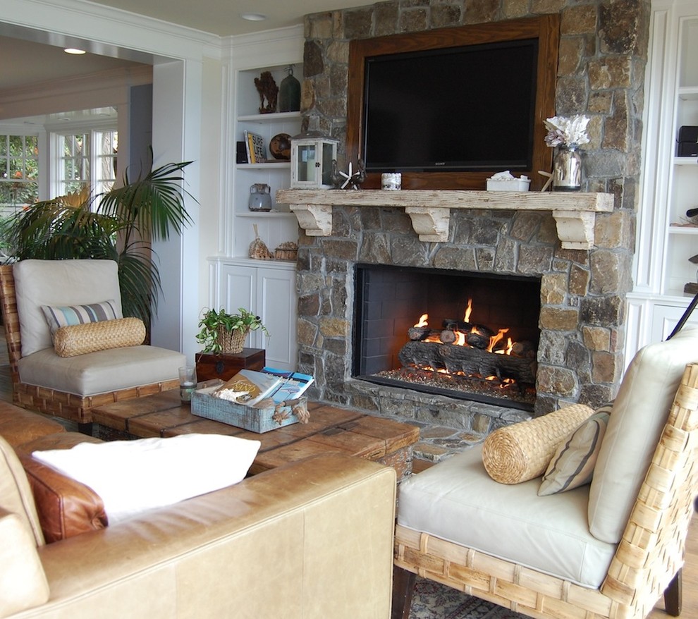 Inspiration for a beach style living room in Orange County with a stone fireplace surround and a wall-mounted tv.