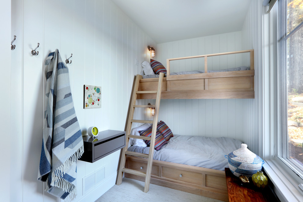 Expansive scandinavian gender-neutral kids' bedroom in Grand Rapids with white walls and carpet for kids 4-10 years old.
