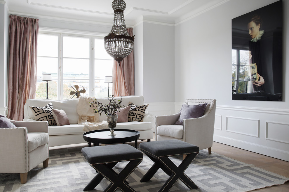 This is an example of a large traditional formal open concept living room in Stockholm with grey walls, light hardwood floors, no fireplace and no tv.