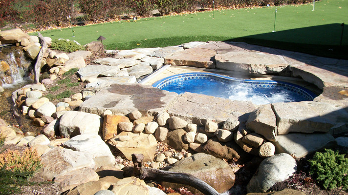 Inspiration for a large transitional backyard concrete paver and kidney-shaped hot tub remodel in Chicago