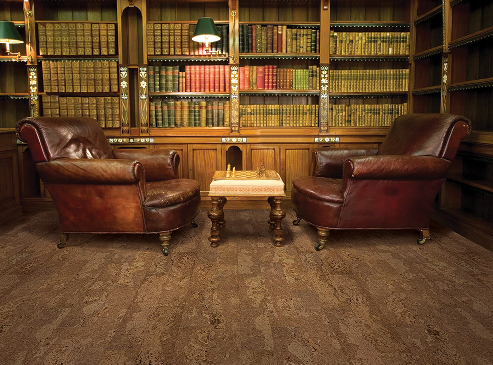 This is an example of a large traditional home office in Other with a library and cork floors.