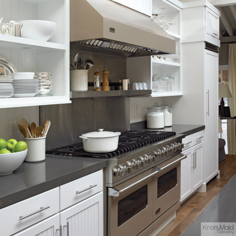 This is an example of a transitional kitchen in New York with beaded inset cabinets and white cabinets.