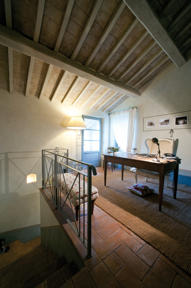 Photo of a small country home studio in Florence with brick floors.