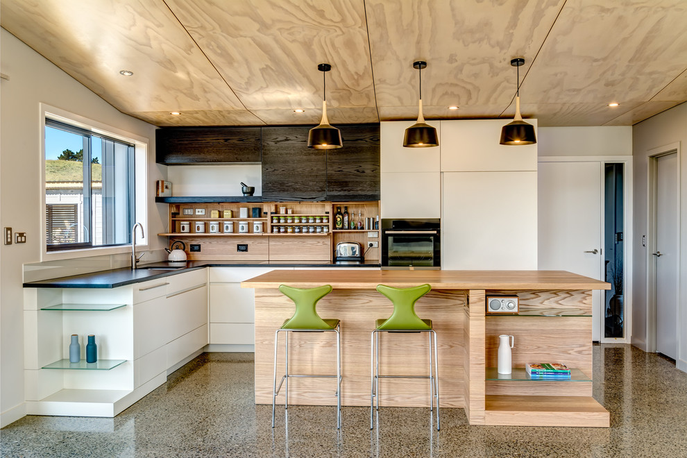 Design ideas for a contemporary kitchen in Other with concrete floors.