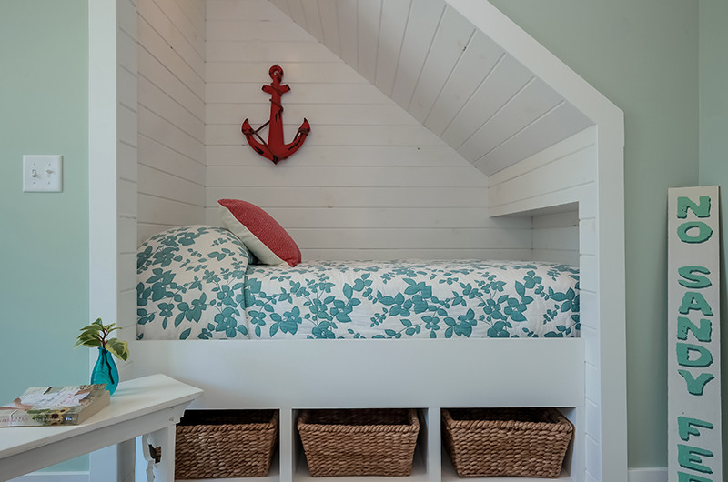 Design ideas for a small beach style kids' bedroom for kids 4-10 years old and girls in Other with blue walls and bamboo floors.