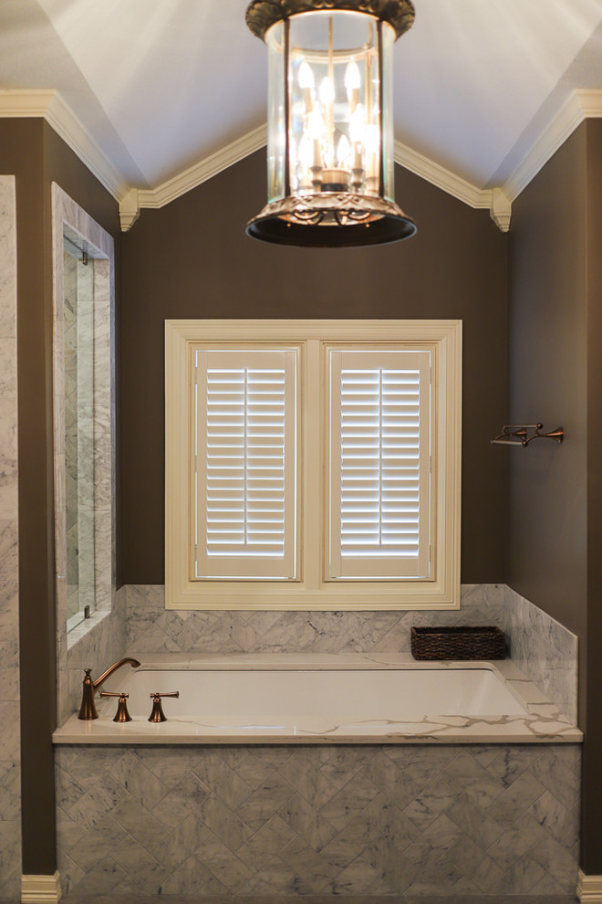 Inspiration for a large transitional master white tile and marble tile porcelain tile and gray floor corner shower remodel with shaker cabinets, dark wood cabinets, an undermount tub, a one-piece toilet, brown walls, an undermount sink, quartz countertops, a hinged shower door and white countertops