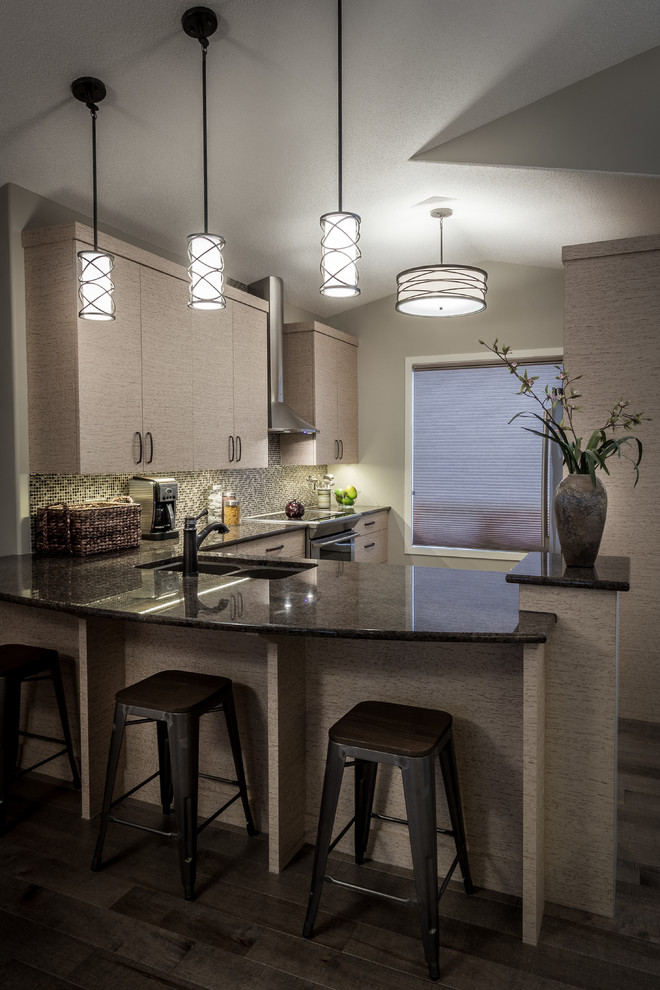 Inspiration for a mid-sized modern u-shaped medium tone wood floor and gray floor enclosed kitchen remodel with a double-bowl sink, flat-panel cabinets, beige cabinets, granite countertops, multicolored backsplash, mosaic tile backsplash, stainless steel appliances and a peninsula