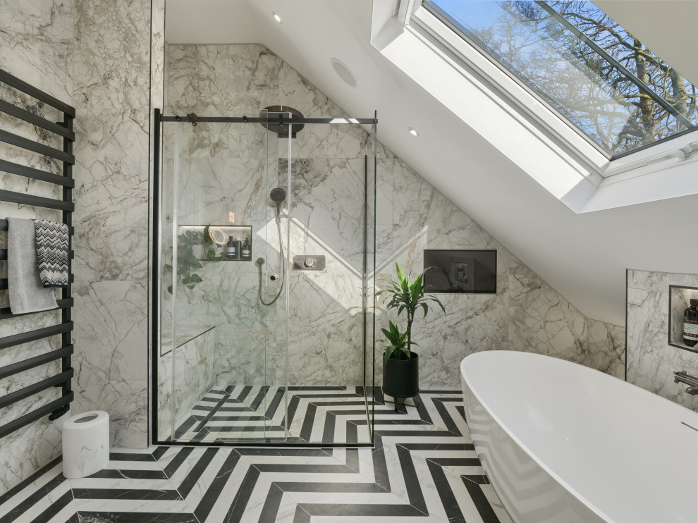 Photo of a large eclectic kids bathroom in Essex with a freestanding tub, a corner shower, beige tile, marble, beige walls, ceramic floors, marble benchtops, multi-coloured floor, a sliding shower screen and a single vanity.