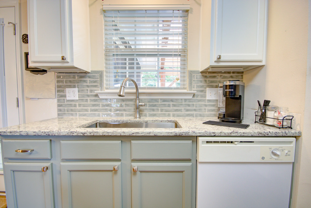Eat-in kitchen - mid-sized transitional u-shaped medium tone wood floor and brown floor eat-in kitchen idea with an undermount sink, shaker cabinets, green cabinets, granite countertops, green backsplash, ceramic backsplash, white appliances, no island and multicolored countertops