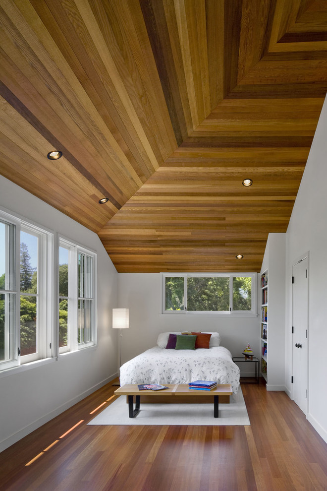 Contemporary bedroom in San Francisco with white walls and medium hardwood floors.