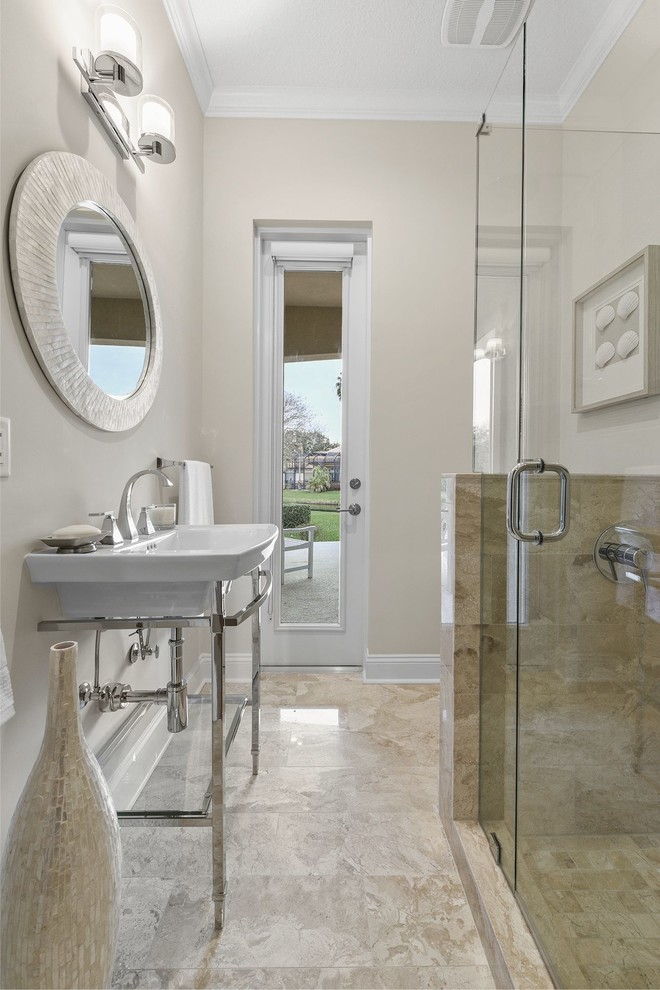 Alcove shower - mid-sized transitional 3/4 beige tile and marble tile marble floor and beige floor alcove shower idea in Jacksonville with a two-piece toilet, beige walls, a console sink and a hinged shower door