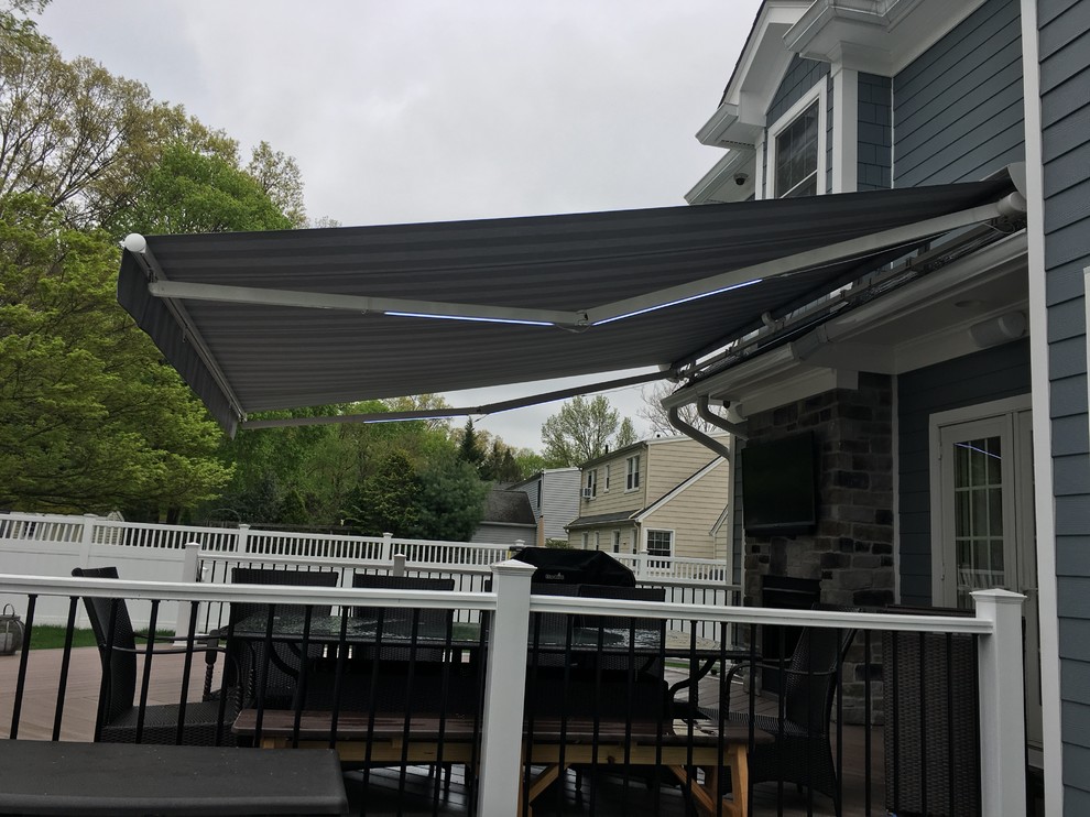 Mid-sized modern backyard deck in New York with an awning.