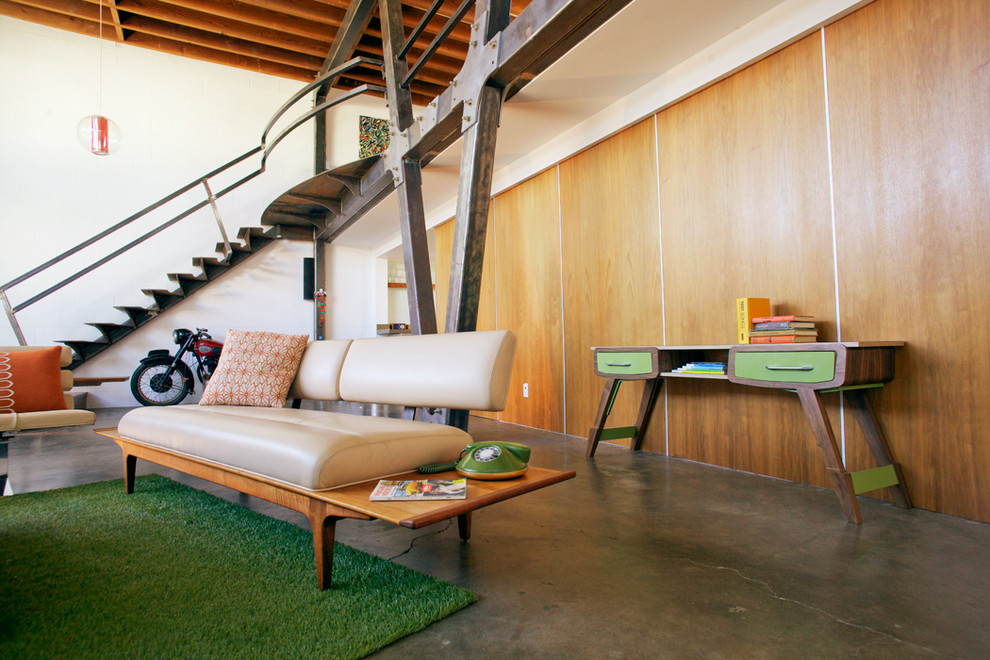 Photo of a large midcentury foyer in Los Angeles with white walls, concrete floors and grey floor.