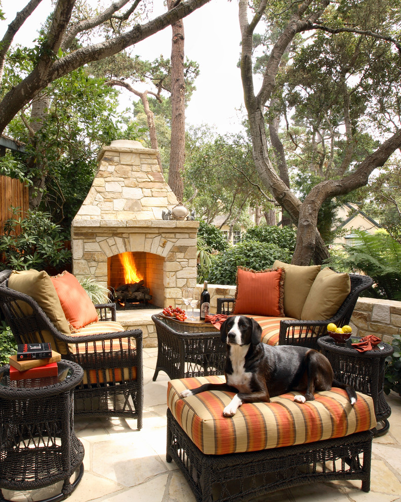 This is an example of a mid-sized traditional backyard patio in San Francisco with a fire feature, natural stone pavers and no cover.