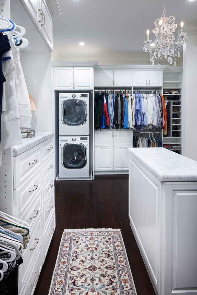 Large trendy gender-neutral dark wood floor walk-in closet photo in Philadelphia with white cabinets and raised-panel cabinets