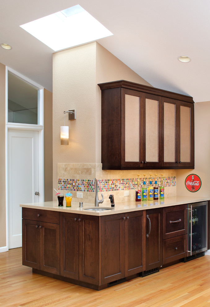 Example of a transitional l-shaped light wood floor wet bar design in San Francisco with an undermount sink, recessed-panel cabinets, dark wood cabinets, quartz countertops and multicolored backsplash