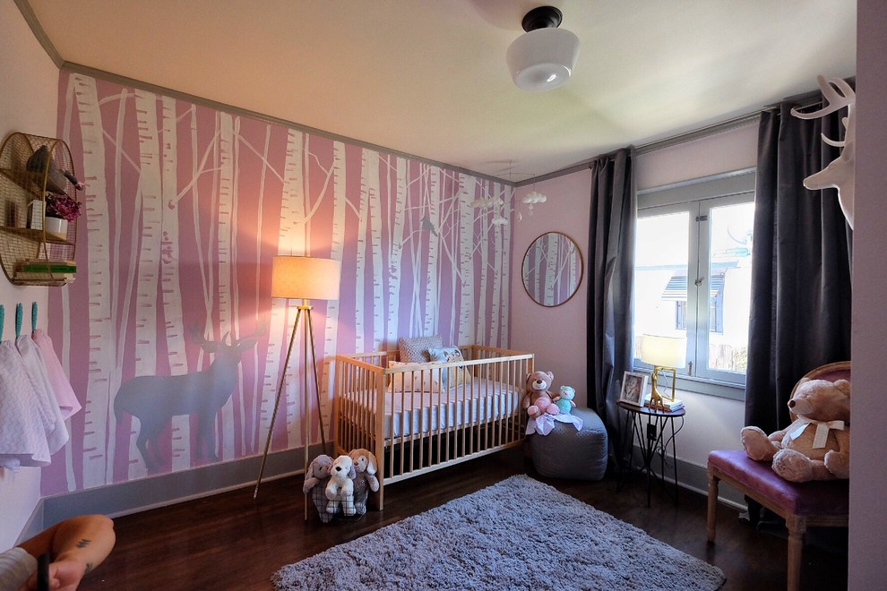 Design ideas for a small contemporary nursery for girls in Los Angeles with pink walls and dark hardwood floors.