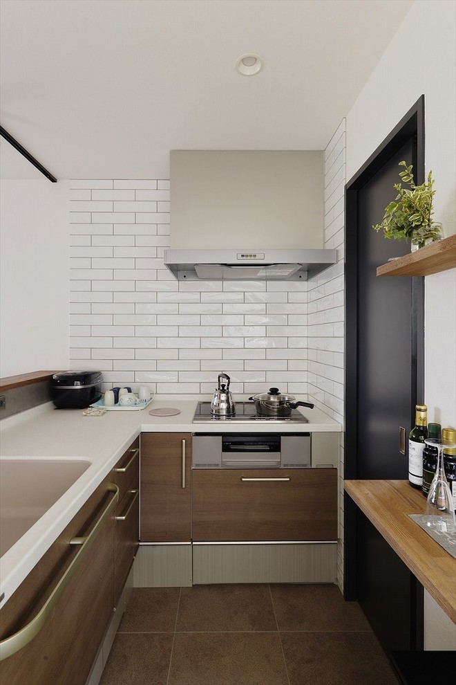 Design ideas for a small industrial kitchen with an integrated sink, flat-panel cabinets, medium wood cabinets, grey splashback, a peninsula, brown floor and brown benchtop.