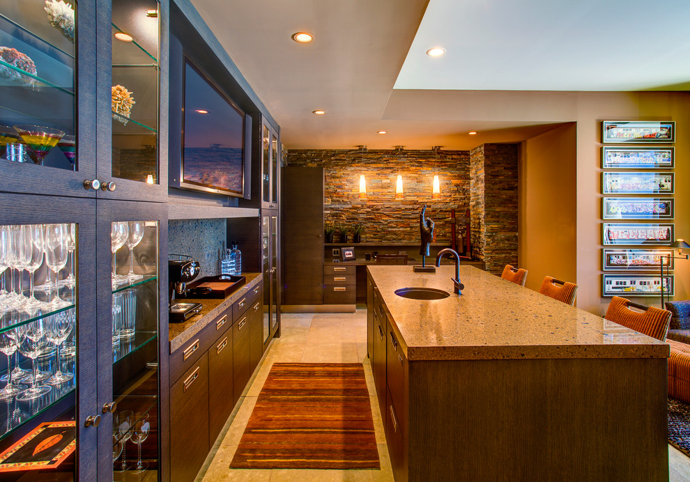 Photo of a large contemporary single-wall seated home bar in Phoenix with an undermount sink, glass-front cabinets, grey cabinets, quartz benchtops, stone slab splashback, travertine floors and beige floor.