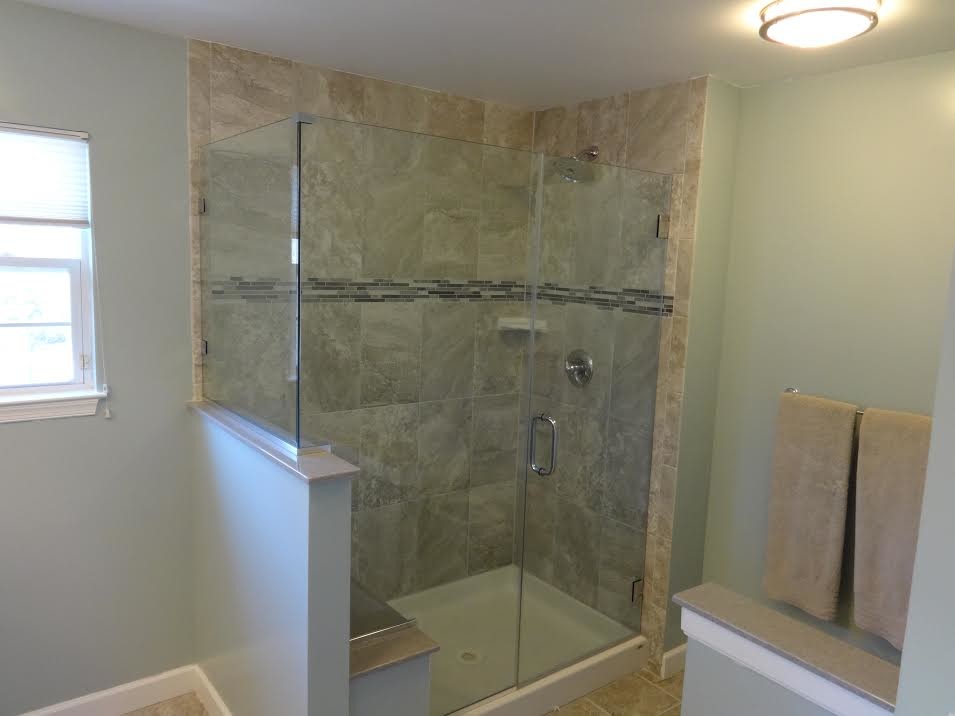 Design ideas for a large traditional master bathroom in Baltimore with an open shower, gray tile, porcelain tile, grey walls, an integrated sink, raised-panel cabinets, dark wood cabinets, marble benchtops and porcelain floors.