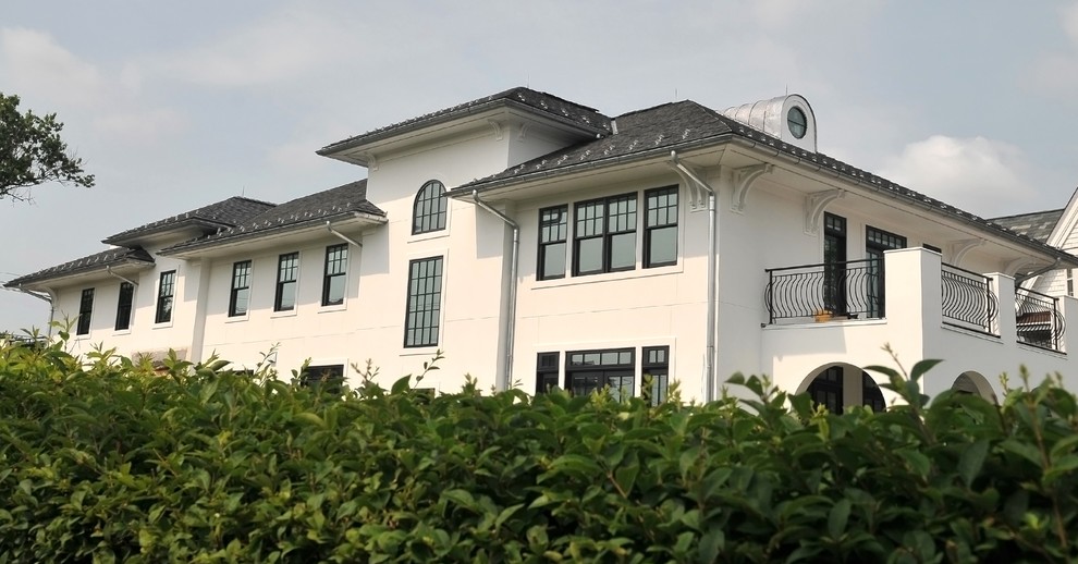 Huge modern white three-story stucco house exterior idea in New York with a hip roof and a shingle roof