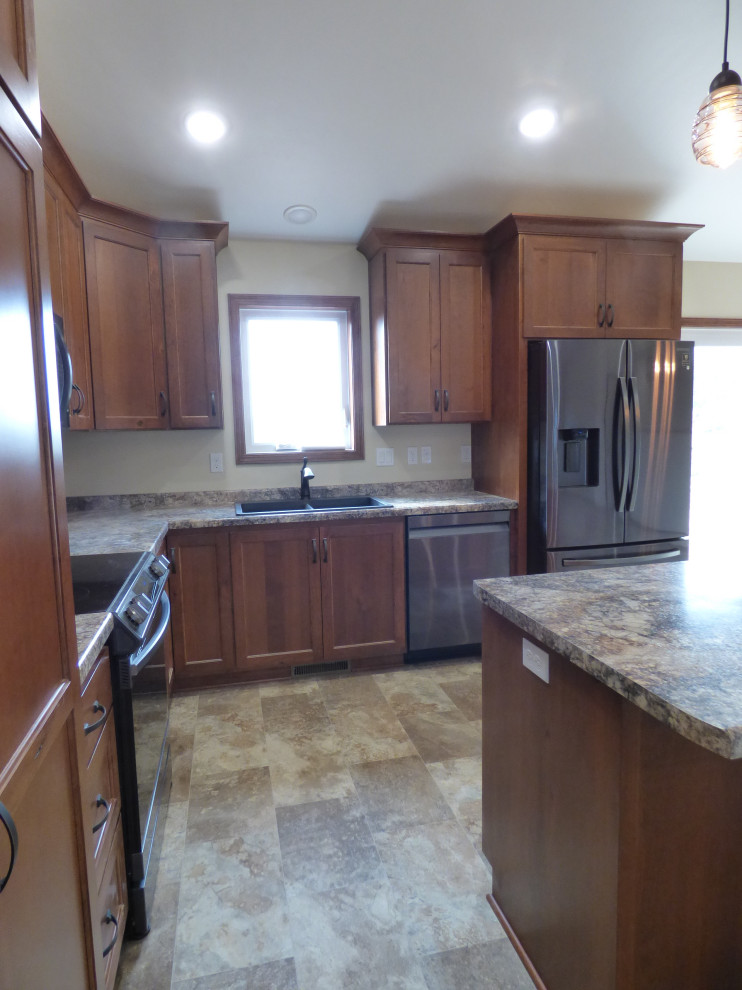 Mid-sized traditional l-shaped open plan kitchen in Other with flat-panel cabinets, medium wood cabinets, laminate benchtops, stainless steel appliances, linoleum floors, with island, beige floor, multi-coloured benchtop and vaulted.
