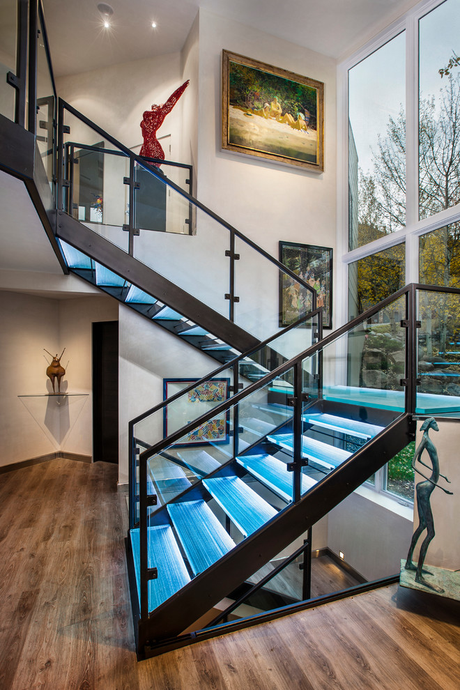 Inspiration for a mid-sized contemporary glass straight staircase in Denver with open risers and glass railing.