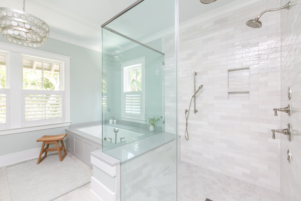 This is an example of a large transitional master bathroom in Charleston with shaker cabinets, grey cabinets, an undermount tub, a curbless shower, a two-piece toilet, gray tile, subway tile, blue walls, porcelain floors, an undermount sink, engineered quartz benchtops, white floor, a hinged shower door, grey benchtops, a shower seat, a double vanity and a built-in vanity.