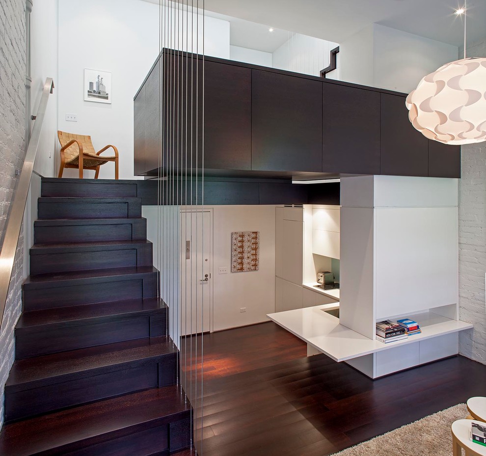 This is an example of a small modern wood straight staircase in New York with wood risers.