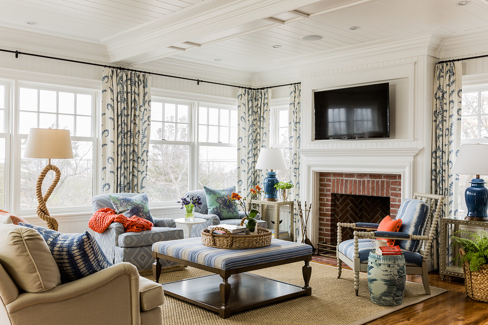 Design ideas for a traditional living room in Boston with white walls, dark hardwood floors, a standard fireplace, a brick fireplace surround and a wall-mounted tv.