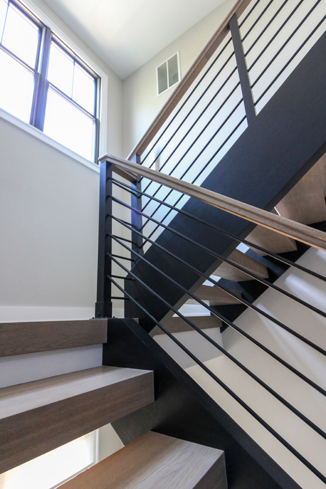 Photo of a large modern wood floating staircase in DC Metro with mixed railing.
