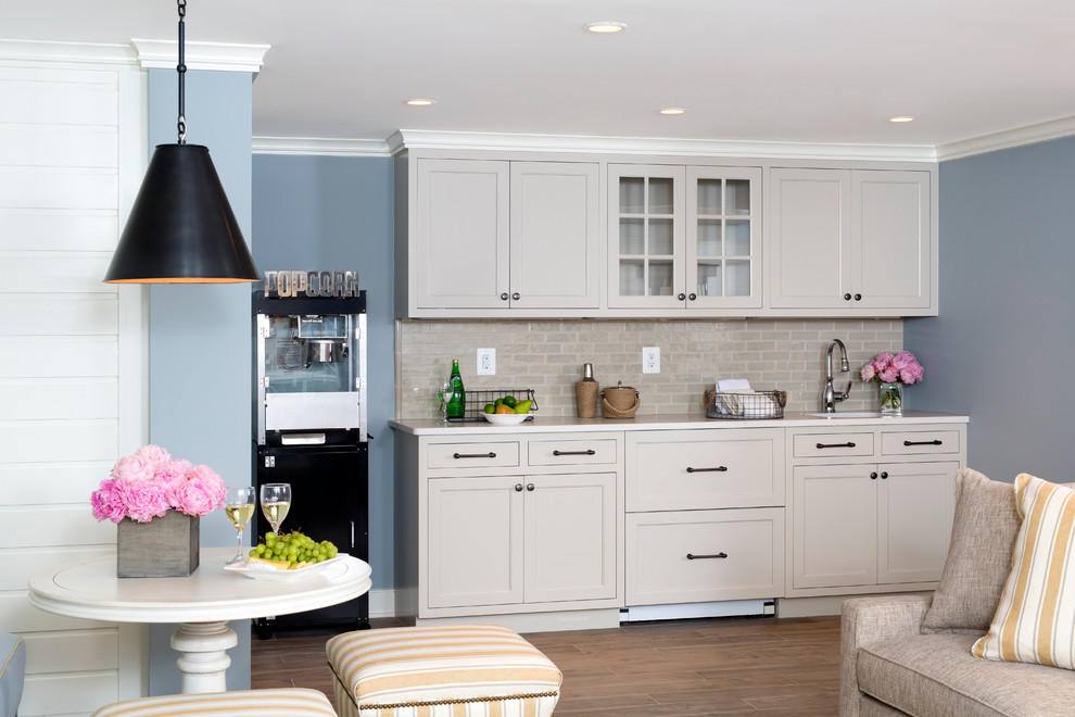 Inspiration for a transitional single-wall wet bar remodel in DC Metro with beige cabinets, marble countertops, beige backsplash, shaker cabinets and subway tile backsplash