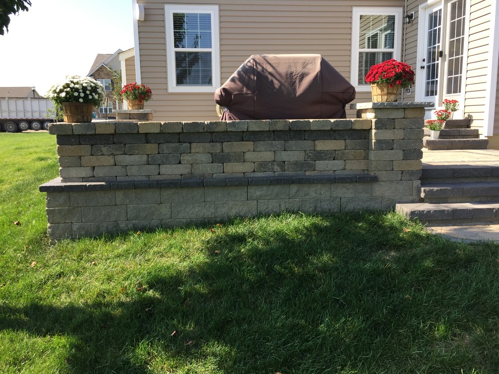 Large country backyard patio in Columbus with brick pavers and no cover.