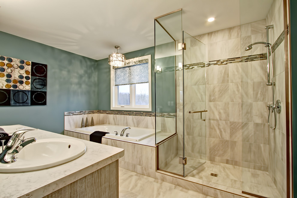 Design ideas for a mid-sized transitional master bathroom in Toronto with flat-panel cabinets, light wood cabinets, a corner tub, a corner shower, gray tile, porcelain tile, green walls, porcelain floors, a drop-in sink and laminate benchtops.