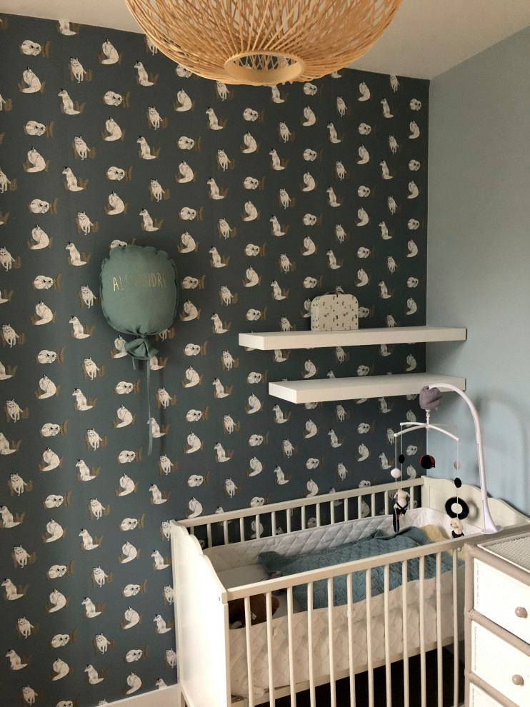 Design ideas for a small contemporary nursery in Paris with blue walls, light hardwood flooring, brown floors and wallpapered walls.