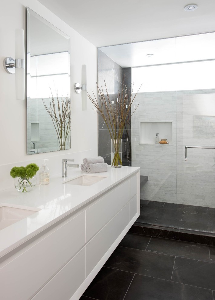 Inspiration for a contemporary bathroom in Los Angeles with engineered quartz benchtops, flat-panel cabinets, white cabinets, an alcove shower, white tile, white walls and an undermount sink.