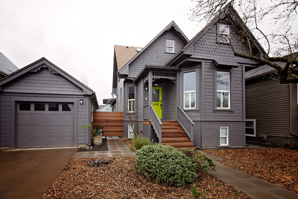 Photo of a traditional two-storey grey house exterior in Portland with wood siding, a gable roof and a shingle roof.