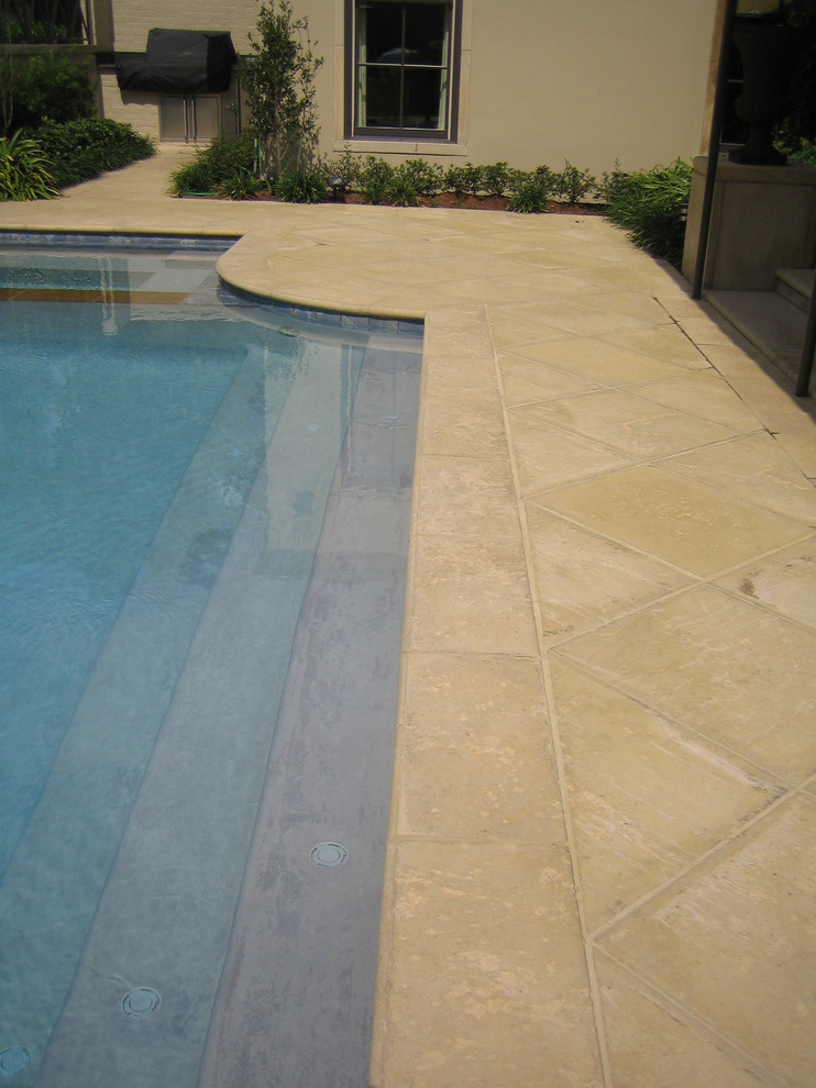 Example of a mid-sized mountain style backyard concrete paver and custom-shaped pool design in Miami