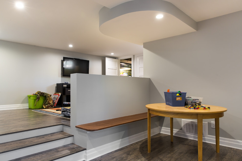 Mid-sized contemporary fully buried basement in Ottawa with grey walls.