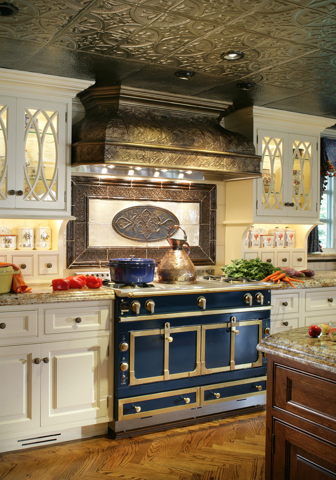 Traditional kitchen in New York with beaded inset cabinets, white cabinets and black appliances.