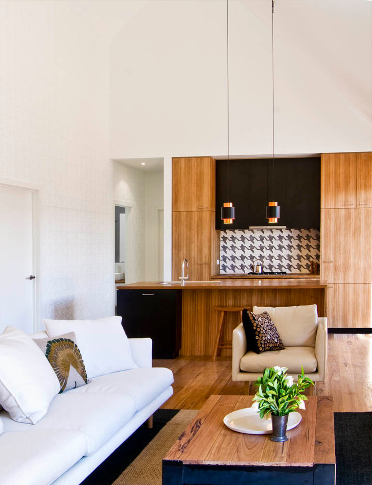 Design ideas for a contemporary living room in Melbourne with light hardwood floors.