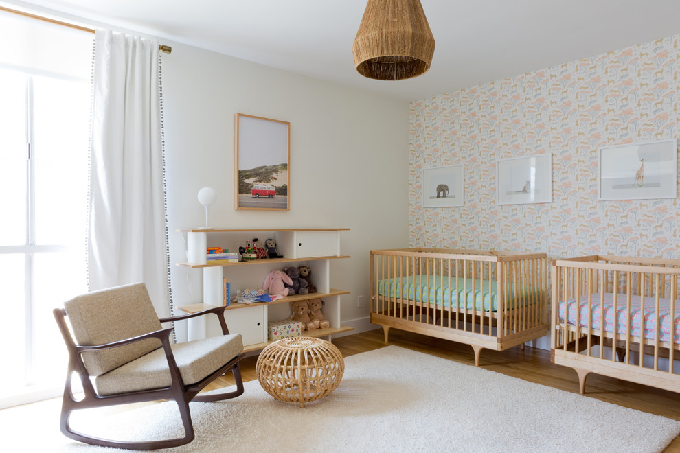 Trendy gender-neutral white floor nursery photo in Los Angeles with multicolored walls