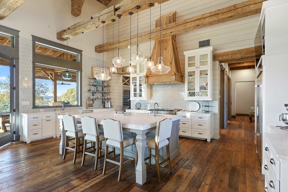 Expansive country u-shaped eat-in kitchen in Austin with raised-panel cabinets, white cabinets and with island.