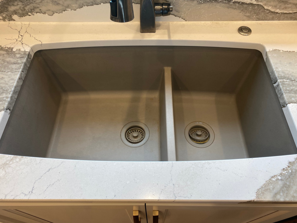 Inspiration for a large transitional l-shaped medium tone wood floor and brown floor open concept kitchen remodel with an undermount sink, flat-panel cabinets, white cabinets, quartz countertops, multicolored backsplash, quartz backsplash, black appliances, an island and multicolored countertops