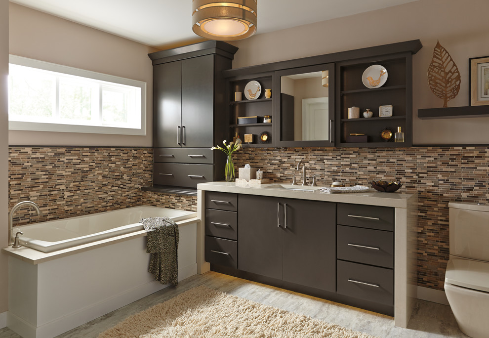 Design ideas for a mid-sized contemporary master bathroom in Grand Rapids with flat-panel cabinets, brown cabinets, a drop-in tub, a two-piece toilet, multi-coloured tile, glass tile, beige walls, travertine floors, an undermount sink, marble benchtops and beige floor.