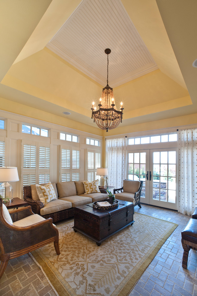 Inspiration for a large traditional living room in Louisville with beige walls and brick floors.