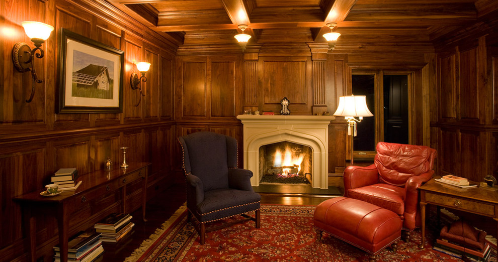 This is an example of a mid-sized traditional study room in Indianapolis with brown walls, medium hardwood floors, a standard fireplace, a concrete fireplace surround and a freestanding desk.