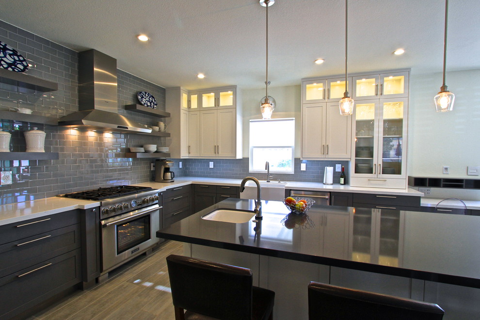 Kitchen - transitional porcelain tile kitchen idea in Orange County with glass tile backsplash and an island