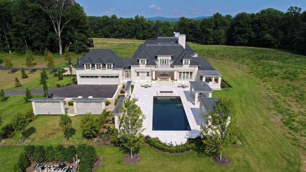 Example of a large transitional courtyard stone and rectangular lap pool design in DC Metro